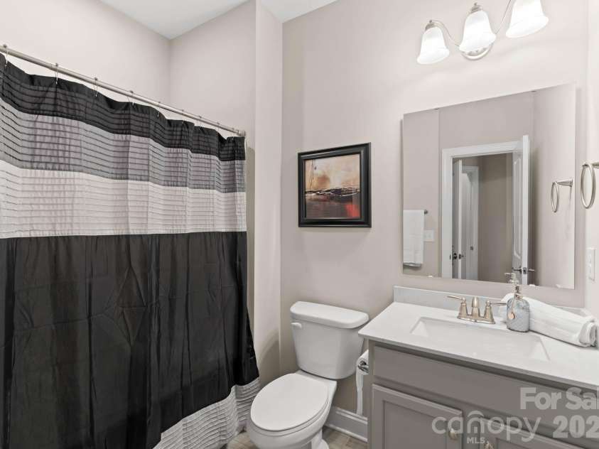 1053 Harlow's Crossing Drive, Matthews, NC 28104.  MLS# CAR4353232, YatesRealty ID 22111. Full bathroom with vanity and shower/tub combo
