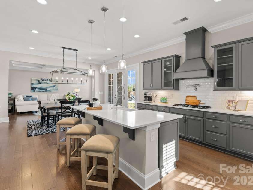 1053 Harlow's Crossing Drive, Matthews, NC 28104.  MLS# CAR4353232, YatesRealty ID 22111. Kitchen flowing into main living and dining areas
