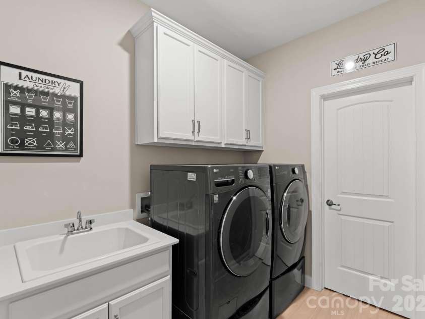 1053 Harlow's Crossing Drive, Matthews, NC 28104.  MLS# CAR4353232, YatesRealty ID 22111. Laundry room with cabinetry and utility sink