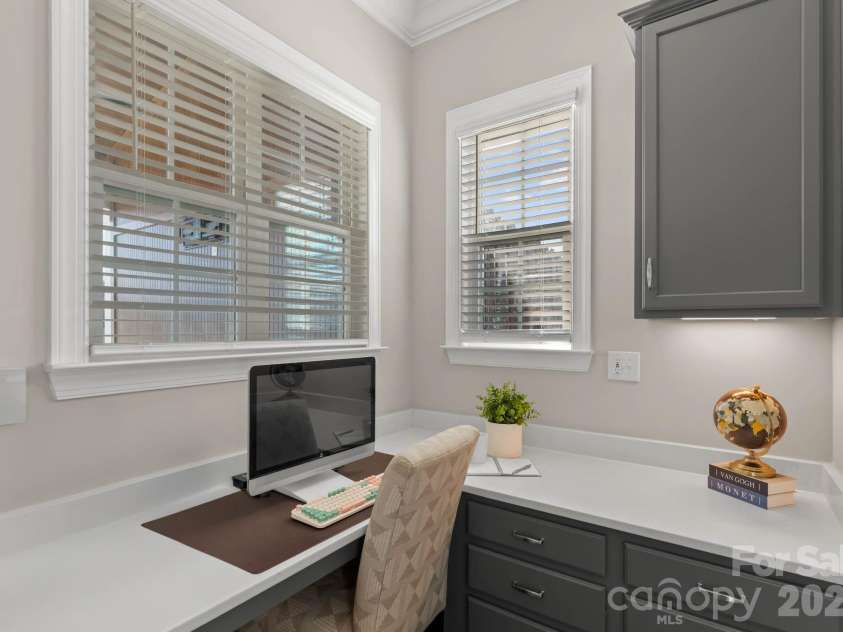1053 Harlow's Crossing Drive, Matthews, NC 28104.  MLS# CAR4353232, YatesRealty ID 22111. Main level office with built-in workspace and natural light