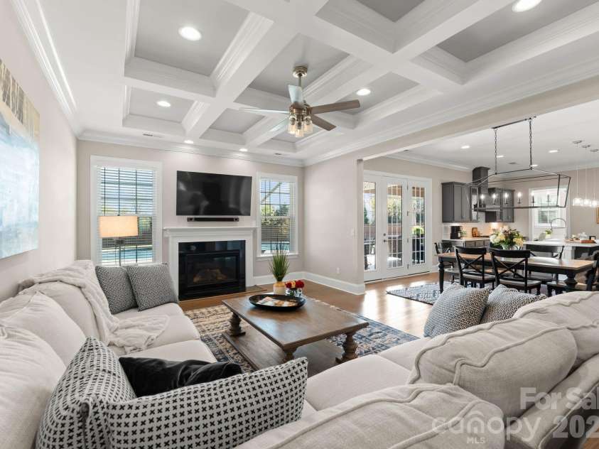 1053 Harlow's Crossing Drive, Matthews, NC 28104.  MLS# CAR4353232, YatesRealty ID 22111. Open-concept living area connecting seamlessly to dining and kitchen