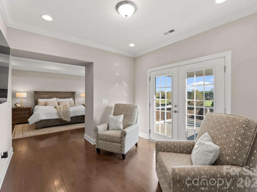 1053 Harlow's Crossing Drive, Matthews, NC 28104.  MLS# CAR4353232, YatesRealty ID 22111. Sitting area off primary suite with access to private balcony