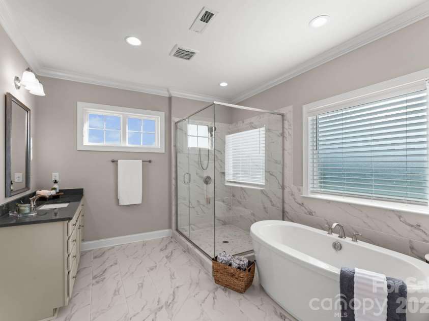 1053 Harlow's Crossing Drive, Matthews, NC 28104.  MLS# CAR4353232, YatesRealty ID 22111. Spa-like primary bathroom