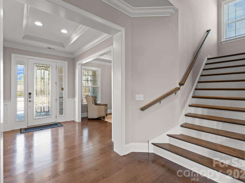 1053 Harlow's Crossing Drive, Matthews, NC 28104.  MLS# CAR4353232, YatesRealty ID 22111. Staircase and entryway with open feel