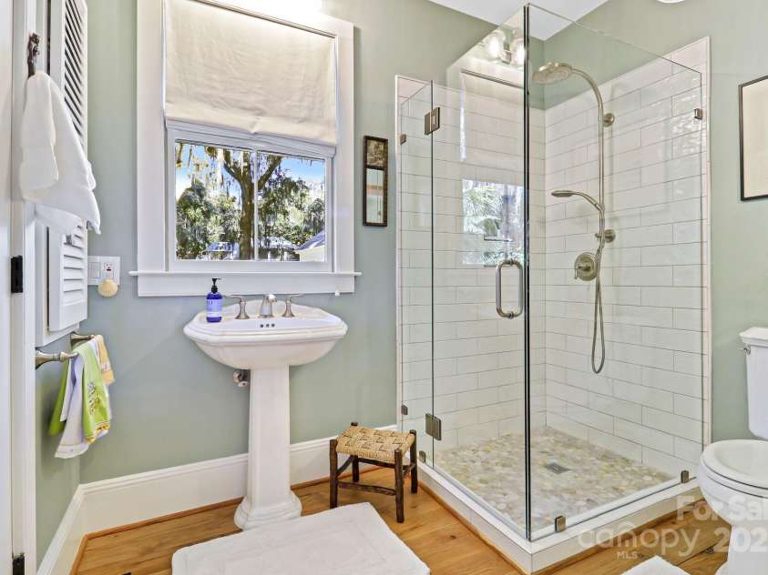 131 Pritchard Street, Bluffton, SC 29910.  MLS# CAR4214365, YatesRealty ID 2212. Updated guest bathroom with frameless glass shower, pedestal sink, large linen closet