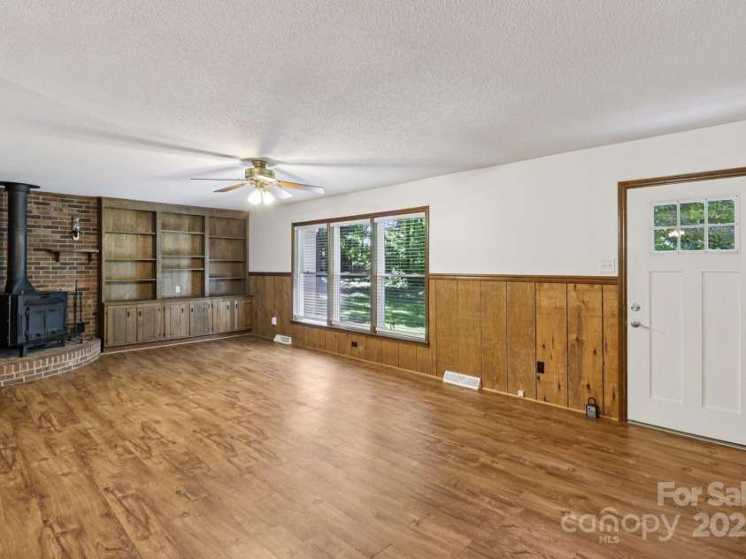 119 Legacy Lane, Harmony, NC 28634.  MLS# CAR4245167, YatesRealty ID 22127. Spacious living room with built ins and a wood buring stove