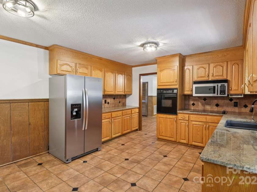 119 Legacy Lane, Harmony, NC 28634.  MLS# CAR4294206, YatesRealty ID 22127. Electric cooktop is newer and refrigerator conveys