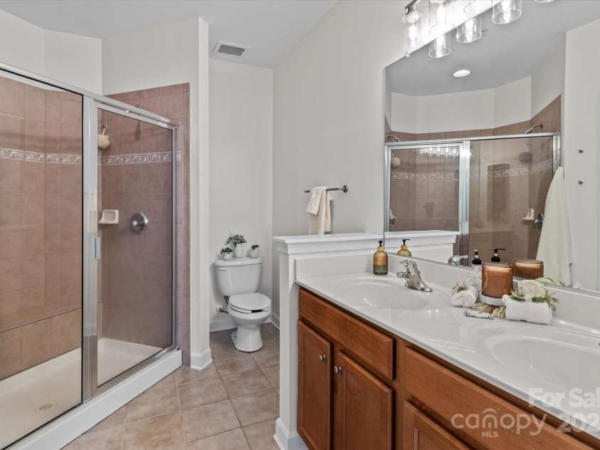 1530 Church Street, Charlotte, NC 28203.  MLS# CAR4259116, YatesRealty ID 22130. Primary full bath #2 with two vanities and a tiled walk-in shower