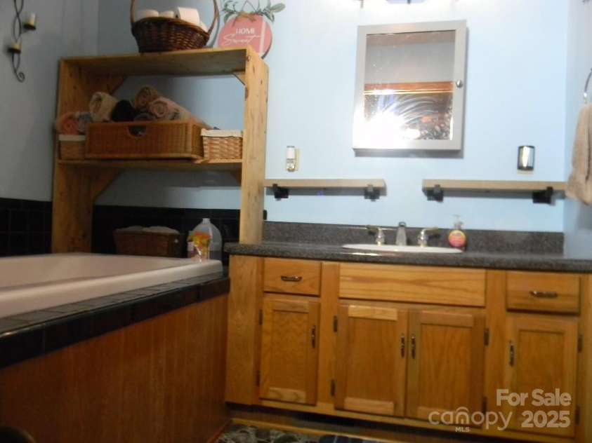1425 Sorrells Cove Road, Clyde, NC 28721.  MLS# CAR4274048, YatesRealty ID 22147. Master Bathroom