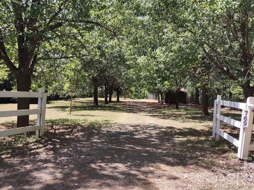 769 Dennis Road, Troy, NC 27371.  MLS# CAR4374021, YatesRealty ID 22151. White fence entry with security cable