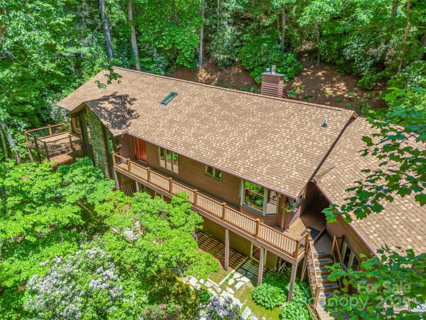 172 Overlook Drive, Flat Rock, NC 28731.  MLS# CAR4224391, YatesRealty ID 2217. Nestled among rhododendron and laurel.