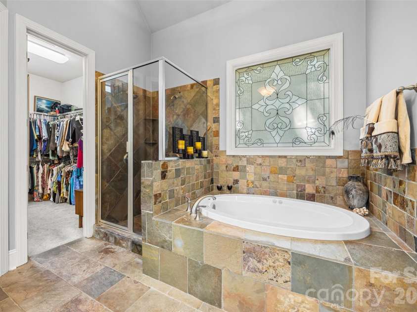 5826 Natoma Road, Clover, SC 29710.  MLS# CAR4372920, YatesRealty ID 22174. Primary bath with tile shower and Jacuzzi tub