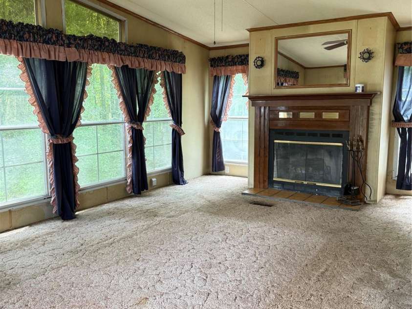 13080 Philadelphia Church Road, Oakboro, NC 28129.  MLS# CAR4222259, YatesRealty ID 2219. Large sunroom with fireplae