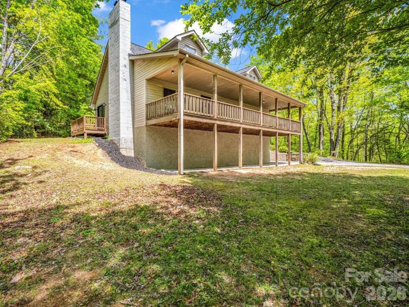 2304 Mountain Page Road, Saluda, NC 28773.  MLS# CAR4366725, YatesRealty ID 22195. Covered deck looking out into a private mountain setting