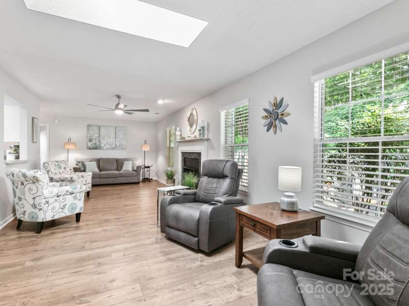 670 New Village Drive, Hendersonville, NC 28791.  MLS# CAR4272117, YatesRealty ID 22206. Den w/ fireplace and skylight