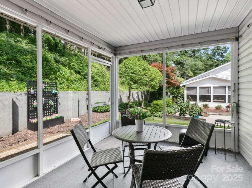 670 New Village Drive, Hendersonville, NC 28791.  MLS# CAR4272117, YatesRealty ID 22206. Serene screen porch