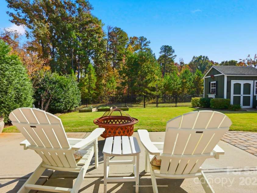 4069 Henshaw Road, Waxhaw, NC 28173.  MLS# CAR4323046, YatesRealty ID 2221. Flat level fenced yard overlooking HOA wooded area.