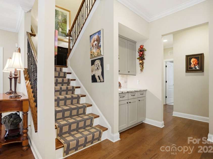 4069 Henshaw Road, Waxhaw, NC 28173.  MLS# CAR4323046, YatesRealty ID 2221. Hardwood treads, iron balusters & custom runner adorn this stairwell. 2nd butler pantry shown.