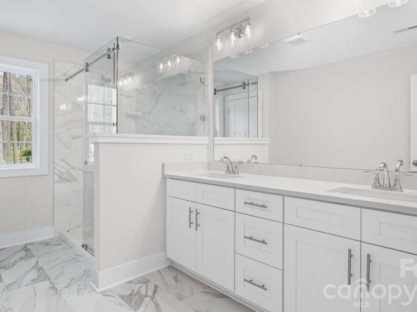 606 Teresa Circle, Waxhaw, NC 28173.  MLS# CAR4363542, YatesRealty ID 22213. Primary Bath w/Tall Vanity, Dual Sinks, Quartz Top, Beautiful Tile.