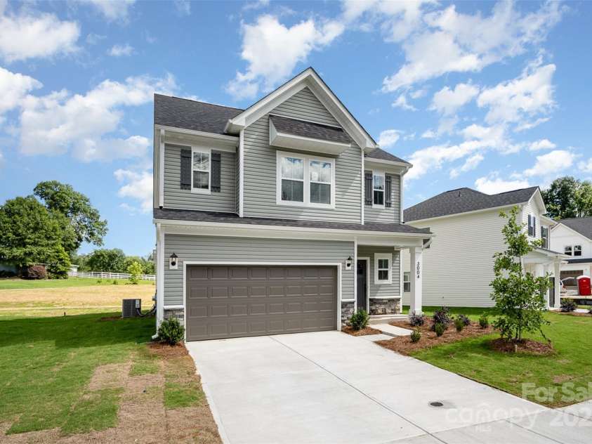1205 Cathey Road, Charlotte, NC 28214.  MLS# CAR4275203, YatesRealty ID 22222. Double-car garage w/ concrete driveway. Representational Photo