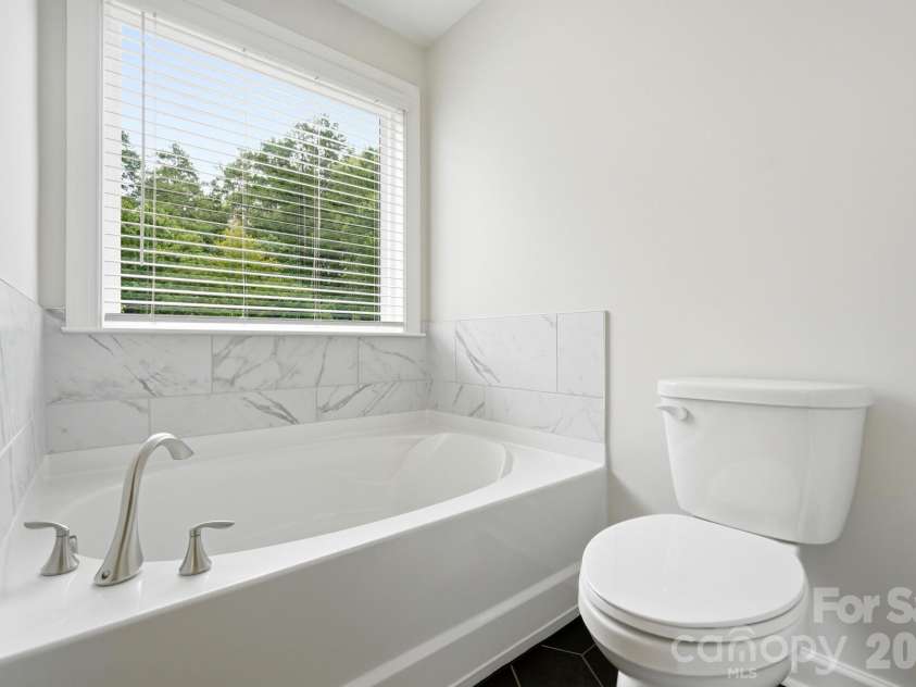 5670 Galloway Drive, Midland, NC 28107.  MLS# CAR4412132, YatesRealty ID 22226. Soaking tub in primary bath