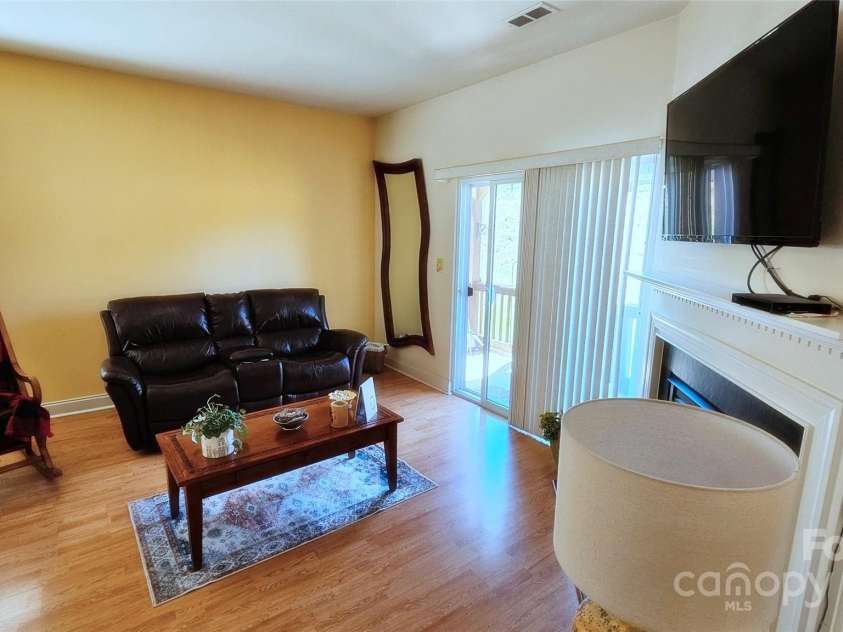 93 Foxden Drive, Fletcher, NC 28732.  MLS# CAR4251885, YatesRealty ID 22237. Living room with sliding door to patio