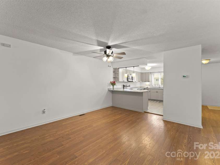 630 Britton Creek Drive, Hendersonville, NC 28791.  MLS# CAR4241236, YatesRealty ID 22259. Great room with dining area