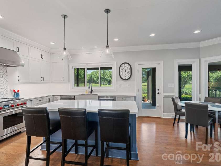 18003 Lochcarron Lane, Cornelius, NC 28031.  MLS# CAR4377616, YatesRealty ID 22279. Kitchen with island and designer tiles