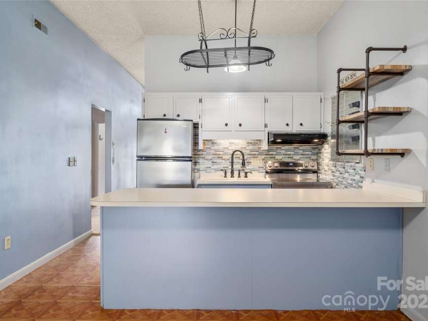 94 Market Street, Maggie Valley, NC 28751.  MLS# CAR4277066, YatesRealty ID 2228. Breakfast Bar in the Coutry Kitchen