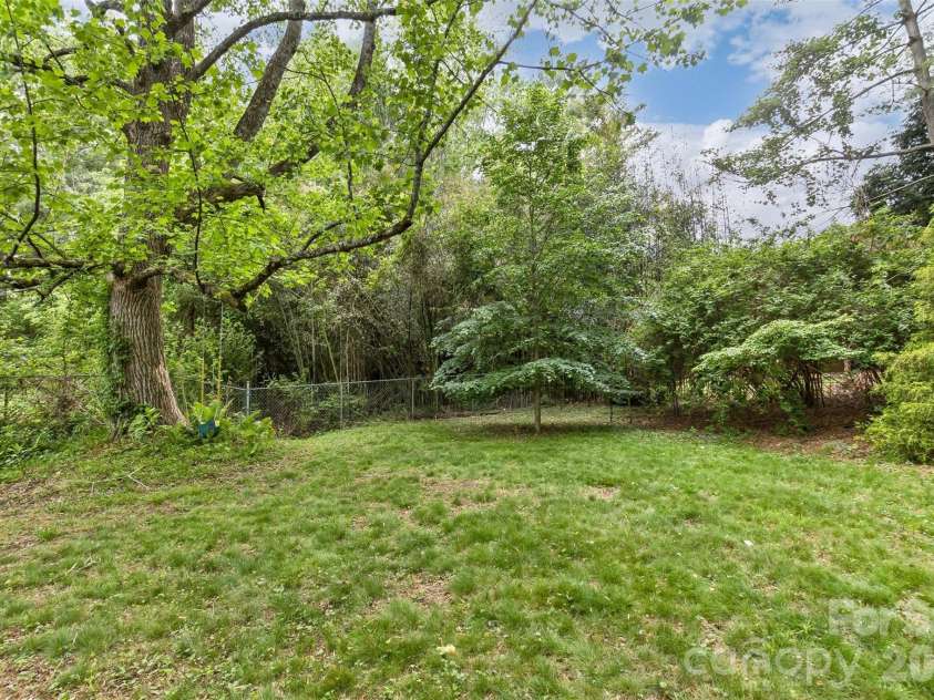 7 Teaneck Circle, Hendersonville, NC 28791.  MLS# CAR4369967, YatesRealty ID 22283. Lush and green