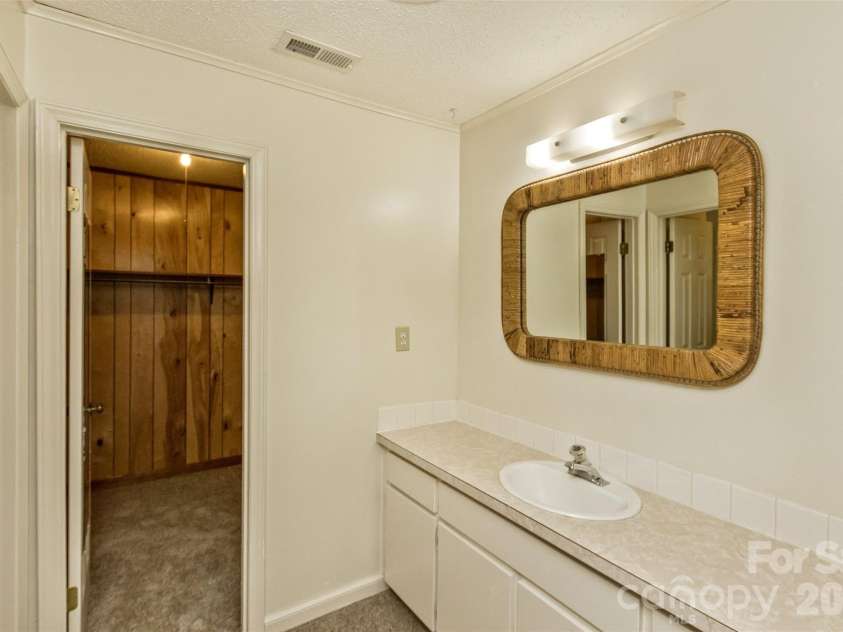 7 Teaneck Circle, Hendersonville, NC 28791.  MLS# CAR4369967, YatesRealty ID 22283. Primary bedroom's ensuite bath area