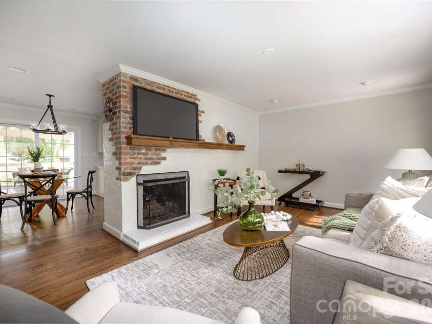 4601 General Pershing Drive, Charlotte, NC 28209.  MLS# CAR4379524, YatesRealty ID 22296. Exposed brick fireplace with wood mantel 