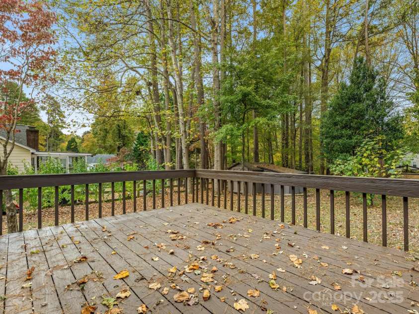 9701 Kent Village Drive, Charlotte, NC 28269.  MLS# CAR4309656, YatesRealty ID 22309. New stained outside deck off kitchen