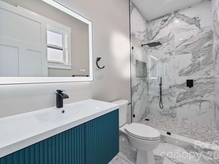 475 Canvasback Road, Mooresville, NC 28117.  MLS# CAR4366182, YatesRealty ID 22319. Floating vanity, LED mirror and tile shower