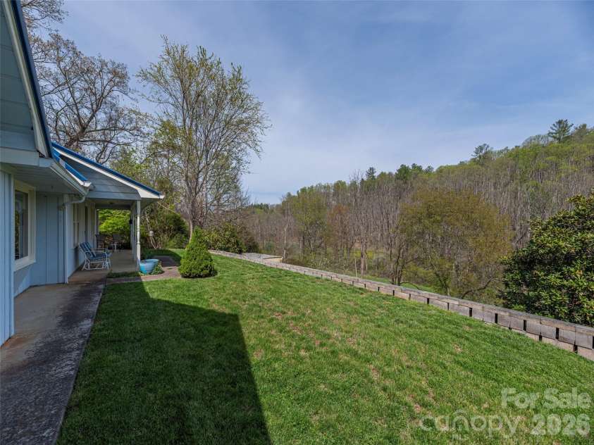 444 Martin Branch Road, Leicester, NC 28748.  MLS# CAR4369223, YatesRealty ID 22320. Gently sloping front yard that leads to the barn below left.