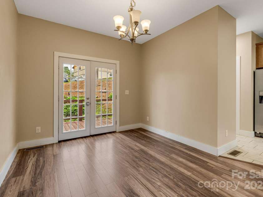 74 Elkwood Avenue, Asheville, NC 28804.  MLS# CAR4251533, YatesRealty ID 22323. Dining area and doors to back deck