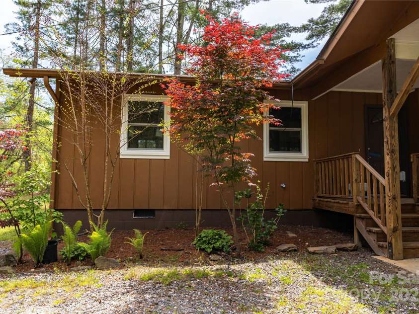 205 Blackwood Road, Cullowhee, NC 28723.  MLS# CAR4249157, YatesRealty ID 22339. Lovely landscaping near carport
