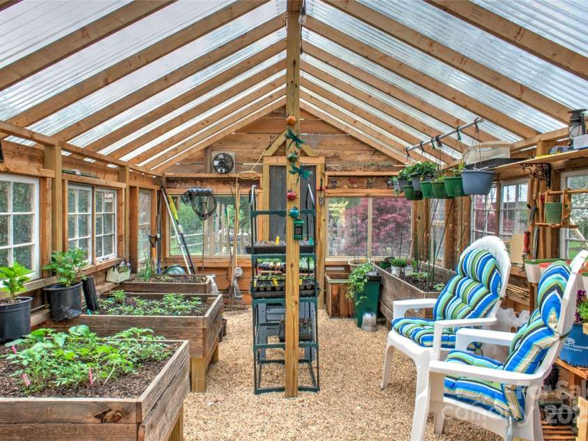 756 Price Road, Hendersonville, NC 28739.  MLS# CAR4208399, YatesRealty ID 22341. Greenhouse interior-sustainable living!