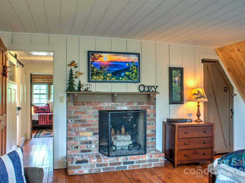 756 Price Road, Hendersonville, NC 28739.  MLS# CAR4208399, YatesRealty ID 22341. Primary bedroom with fireplace