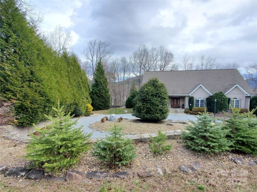 526 Grand Oaks Drive, Hendersonville, NC 28792.  MLS# CAR4239687, YatesRealty ID 22359. Circular Drive in Front & Wall of Green Giants for Privacy