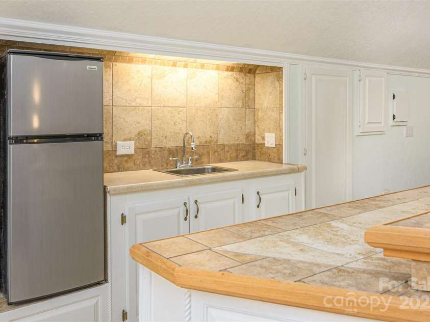 526 Grand Oaks Drive, Hendersonville, NC 28792.  MLS# CAR4239687, YatesRealty ID 22359. Kitchenette has Fridge, Microwave, DBL Burner Induction Hot Plate