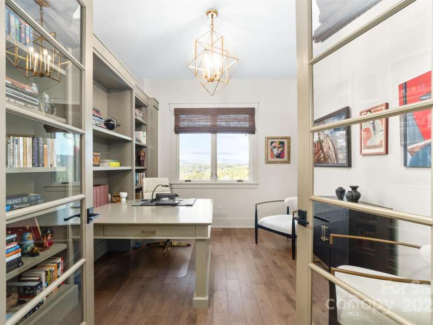 68 Cinch Knot Drive, Nebo, NC 28761.  MLS# CAR4233155, YatesRealty ID 22370. Let the views inspire you in the office/creative studio with custom bookcase and desk on the main level.