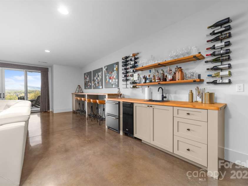 68 Cinch Knot Drive, Nebo, NC 28761.  MLS# CAR4233155, YatesRealty ID 22370. Lower level game room includes big mountain views with entertainment wet-bar and walk out to the patio and pool area.