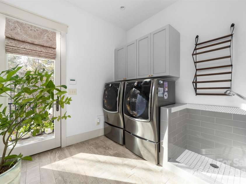 68 Cinch Knot Drive, Nebo, NC 28761.  MLS# CAR4233155, YatesRealty ID 22370. Main level laundry/mud room has walk-out to the patio and includes this fabulous dog/pet shower.