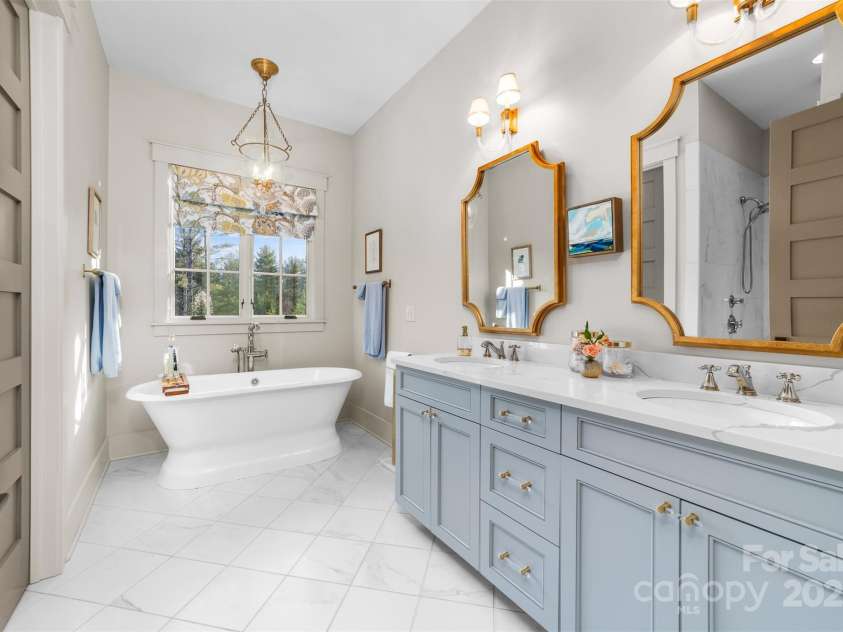 68 Cinch Knot Drive, Nebo, NC 28761.  MLS# CAR4233155, YatesRealty ID 22370. Primary suite bath offers full shower, double vanity and luxurious soaking tub.