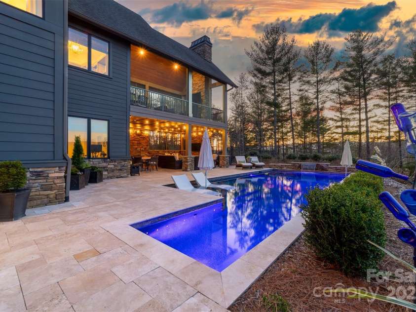 68 Cinch Knot Drive, Nebo, NC 28761.  MLS# CAR4233155, YatesRealty ID 22370. The tasteful patio and pool area blend into the woodland landscaping.