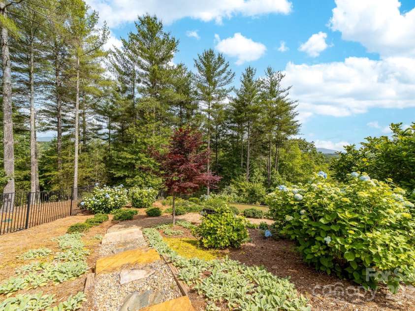 68 Cinch Knot Drive, Nebo, NC 28761.  MLS# CAR4233155, YatesRealty ID 22370. Thoughtful landscaping design is terraced with stairs among the flowering gardens.