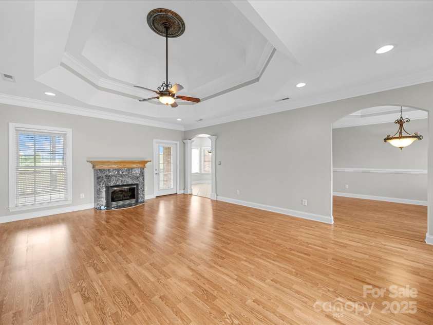 514 Clover Leaf Road, Marshville, NC 28103.  MLS# CAR4247739, YatesRealty ID 22377. Living room with gas fireplace. Access to screened back patio