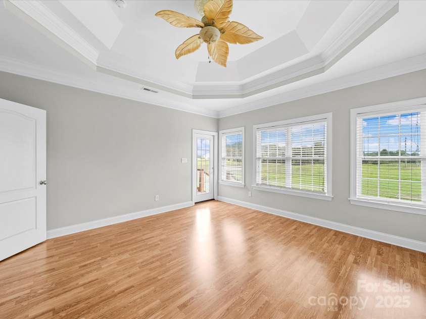 514 Clover Leaf Road, Marshville, NC 28103.  MLS# CAR4247739, YatesRealty ID 22377. Primary bedroom with view of the backyard and access to back patio