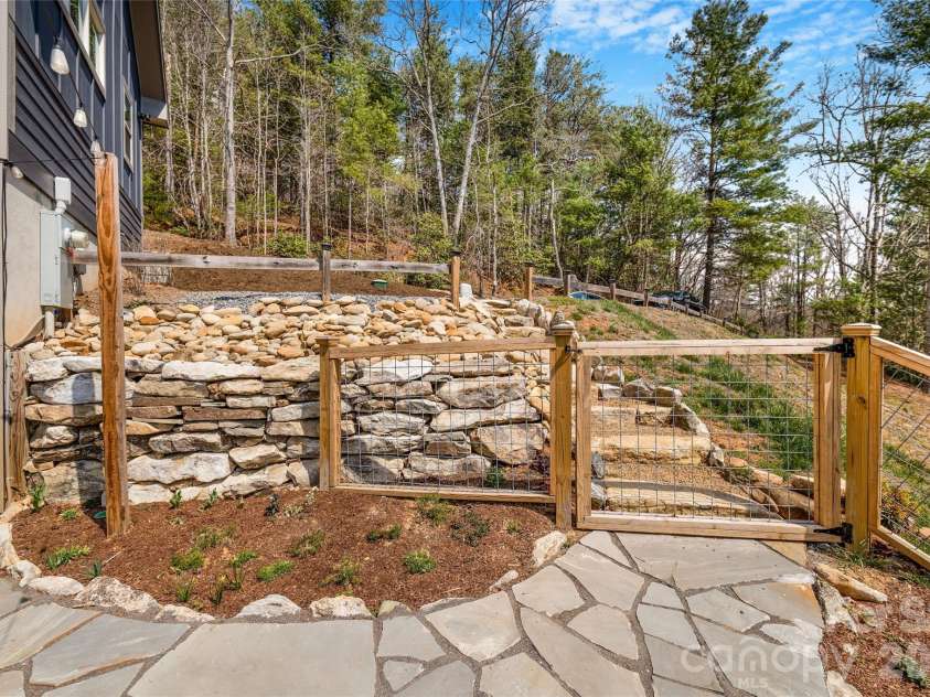 54 Weldon Way, Fairview, NC 28730.  MLS# CAR4353772, YatesRealty ID 22380. Custom stonework and a fenced yard - ready to enjoy! 